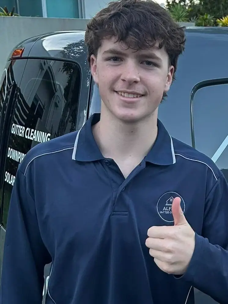 Alfie from Alfie's Gutter Cleaning standing beside the signwritten work van on the Sunshine Coast